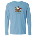 A light blue long-sleeve crewneck t-shirt featuring a cartoon graphic of a dog wearing sunglasses and a brown suit, holding a red suitcase, with the text 'all booked up' printed below.