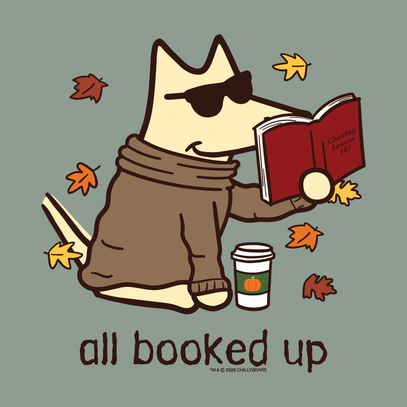 A stylized cartoon dog wearing dark sunglasses and a brown sweater sits on a muted green background, reading a red book with autumn leaves floating around it. Below the illustration, the words 'all booked up' appear, with small text at the bottom reading 'Chilling Lessons 101' and 'Chilliwack Comics'.