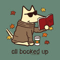 A stylized cartoon fox wearing dark sunglasses, a brown sweater, and a scarf, sitting and reading an open red book. Yellow and orange autumn leaves float around it, with a takeaway coffee cup and the text 'all booked up' below on a muted green background.