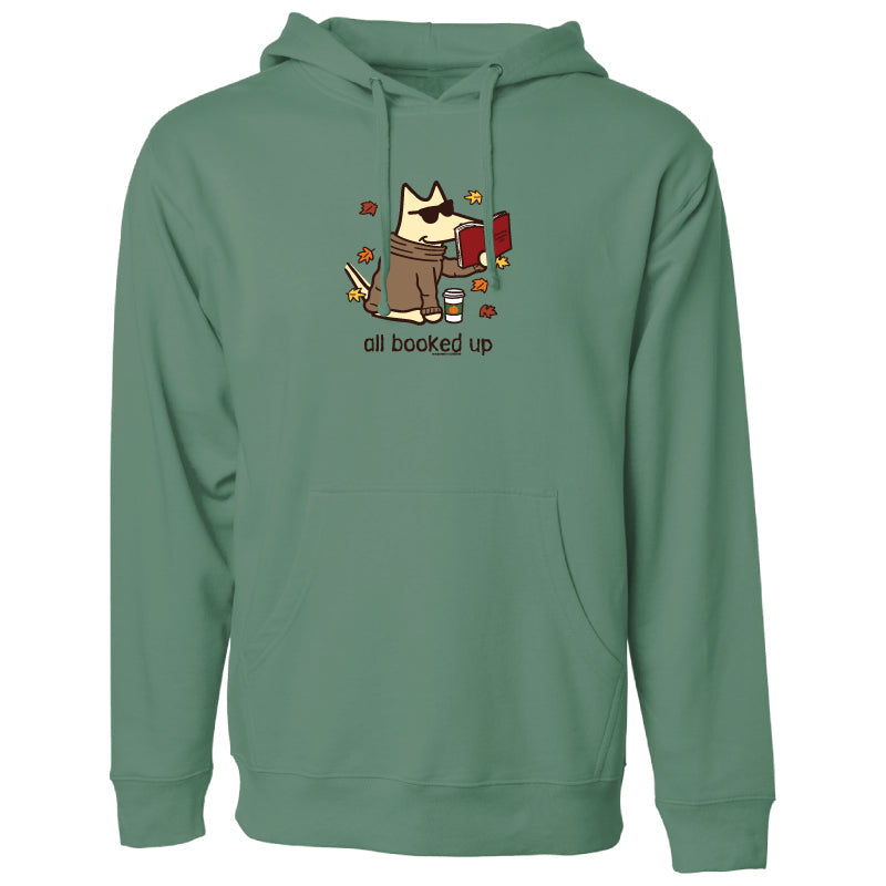 A sage green pullover hoodie featuring a cartoon graphic of a cat wearing sunglasses and holding a red mug, surrounded by autumn leaves, with the text 'all booked up' printed below.
