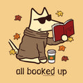 A stylized cartoon dog wearing sunglasses and a brown sweater sits reading a red book, with autumn leaves around it and the text 'all booked up' below. The image appears to be a graphic print design rather than a photographed physical product.