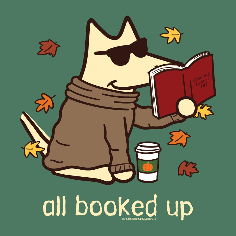 A stylized cartoon dog wearing sunglasses and a brown sweater sits and reads a red book, with autumn leaves around it, a takeaway coffee cup, and the text 'all booked up' on a muted green background. Small text at the bottom reads 'TM & © 2026 CHERRYBEANS'.