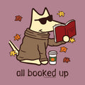 A stylized cartoon dog wearing sunglasses and a brown sweater sits reading a red book, with autumn leaves around it and the text 'all booked up' below. This appears to be a graphic design on apparel rather than a standalone product photo.