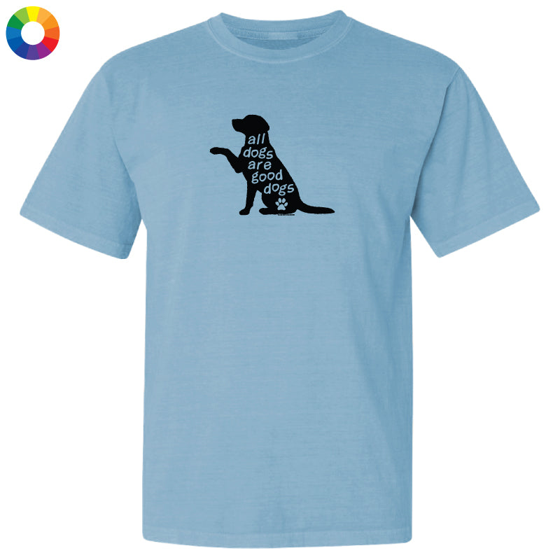 A light blue short-sleeve crewneck t-shirt featuring a black graphic of a sitting dog silhouette with the text 'all dogs are good dogs' and a small paw print.