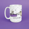 A white ceramic mug with a cartoon illustration of a skeleton in a purple coffin and a dog holding a coffee mug, with the text 'coffin break' below. The mug is set against a solid purple background.