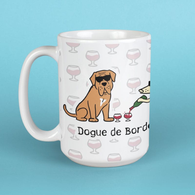 White mug with a Dogue de Bordeaux illustration and wine glass patterns on a blue background