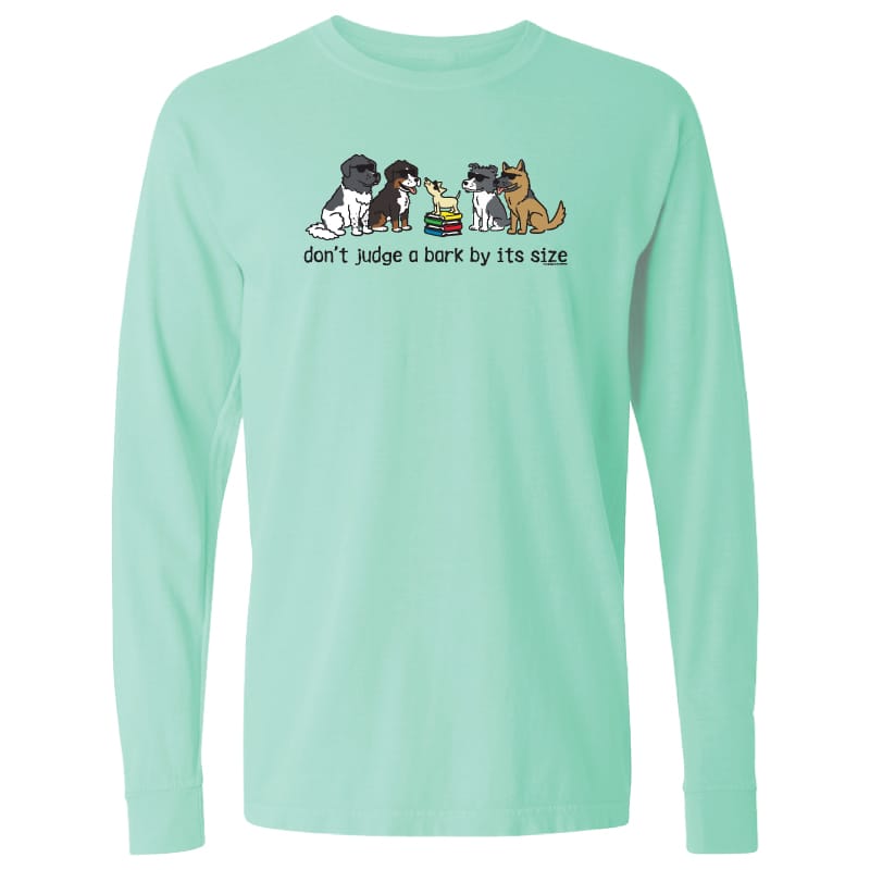 A mint green long-sleeve crewneck t-shirt featuring a graphic of five cartoon dogs and the text 'don't judge a bark by its size' printed on the chest.