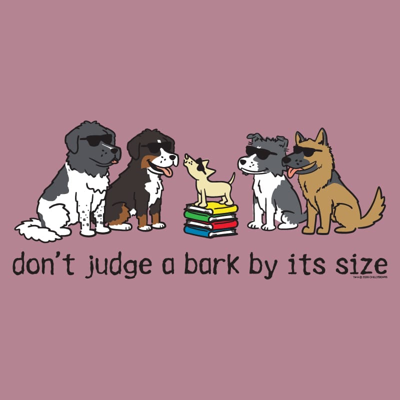 A graphic print featuring cartoon dogs of various sizes and breeds sitting around a small stack of books, with the text 'don't judge a bark by its size' below. The background is a solid dusty mauve color.