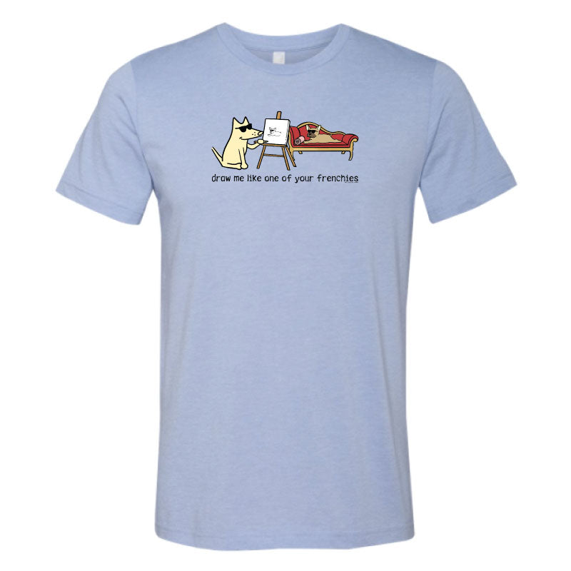 Light blue t-shirt with a graphic of a dog drawing another dog on a white background