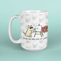 Mug with a cartoon dog drawing a cat, on a light blue background