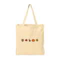 A natural beige canvas tote bag with two shoulder straps, featuring a horizontal row of small autumn-themed illustrations on the front: a paw print, a red maple leaf, a dog, a pumpkin, and a sunflower.