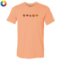 A peach-colored short-sleeve t-shirt with a row of small autumn-themed icons printed across the chest, including a paw print, maple leaf, dog, pumpkin, and sunflower. A circular multicolor color wheel icon is visible in the top-left corner.
