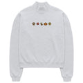 A light gray heather crewneck sweatshirt featuring a horizontal line of small autumn-themed icons on the chest, including a paw print, maple leaf, turkey, pumpkin, and sunflower, displayed on a solid white background.