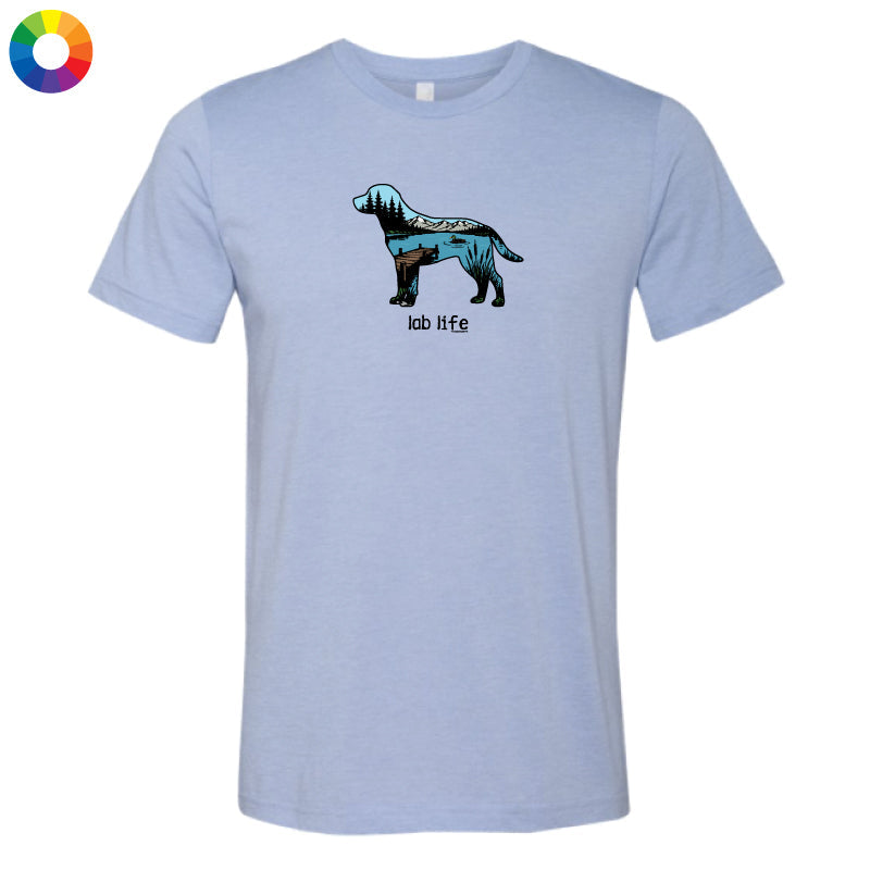 A light heather blue short-sleeve t-shirt with a graphic of a dog cut into colorful geometric sections and the text 'lab life' underneath, displayed on a solid white background.