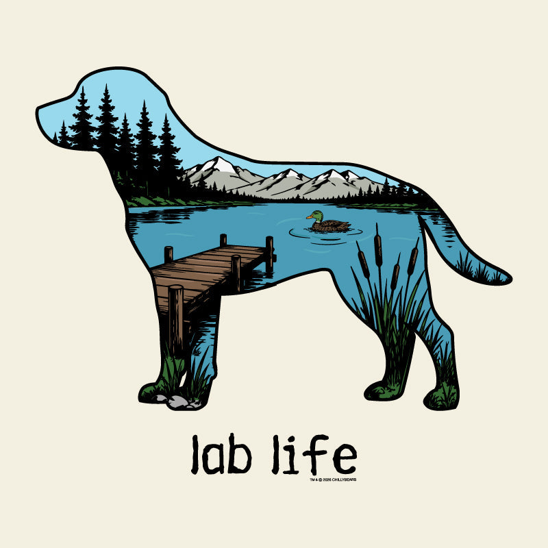 A stylized dog silhouette filled with a lakeside landscape scene, including mountains, pine trees, a dock, reeds, and a duck, above the text 'lab life' on a light cream background.