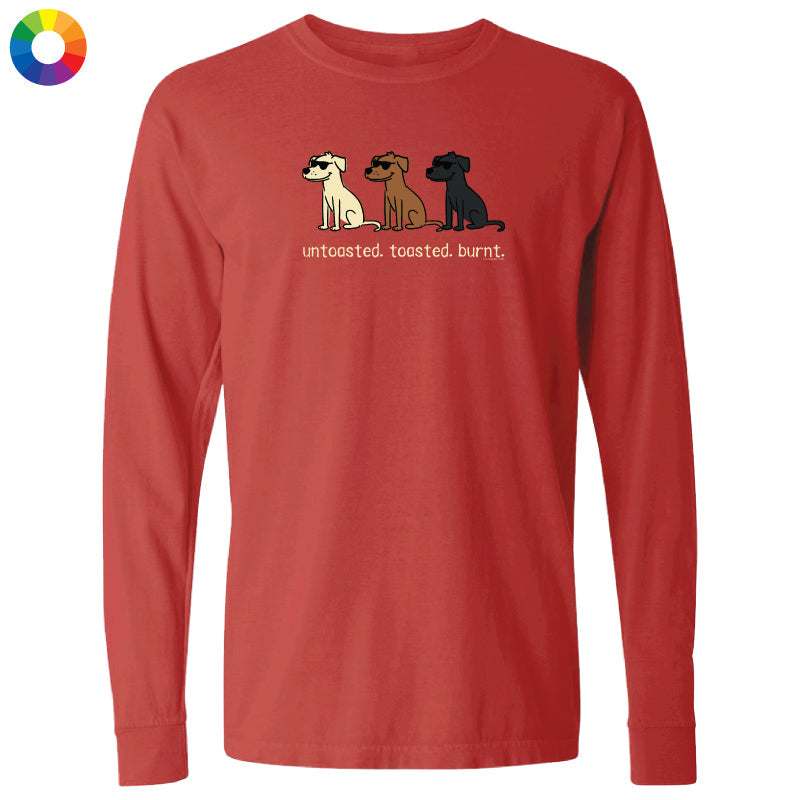 A red long-sleeve t-shirt with a graphic of three dogs in different colors (white, brown, and black) sitting together with the text 'untoasted. toasted.