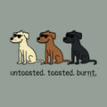 A graphic print featuring three cartoon dogs wearing sunglasses in cream, brown, and black, with the text 'untasted. toasted.