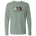 A sage green long-sleeve t-shirt with a graphic of three dogs (white, brown, and black) and the text 'untasted. toasted.