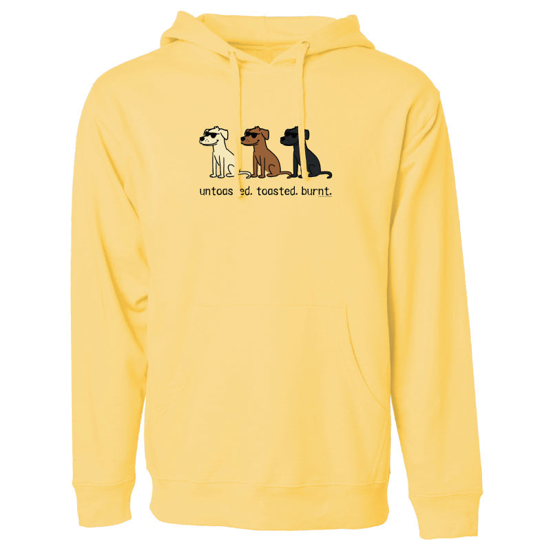 A light yellow pullover hoodie with a front graphic showing three dogs and the text 'untouched burnt.' on the chest, displayed against a solid white background.