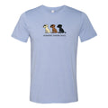 A light blue heather crewneck t-shirt featuring a graphic of three cartoon dogs in white, brown, and black, with the text 'uncoated, toasted, burnt.' printed below them.