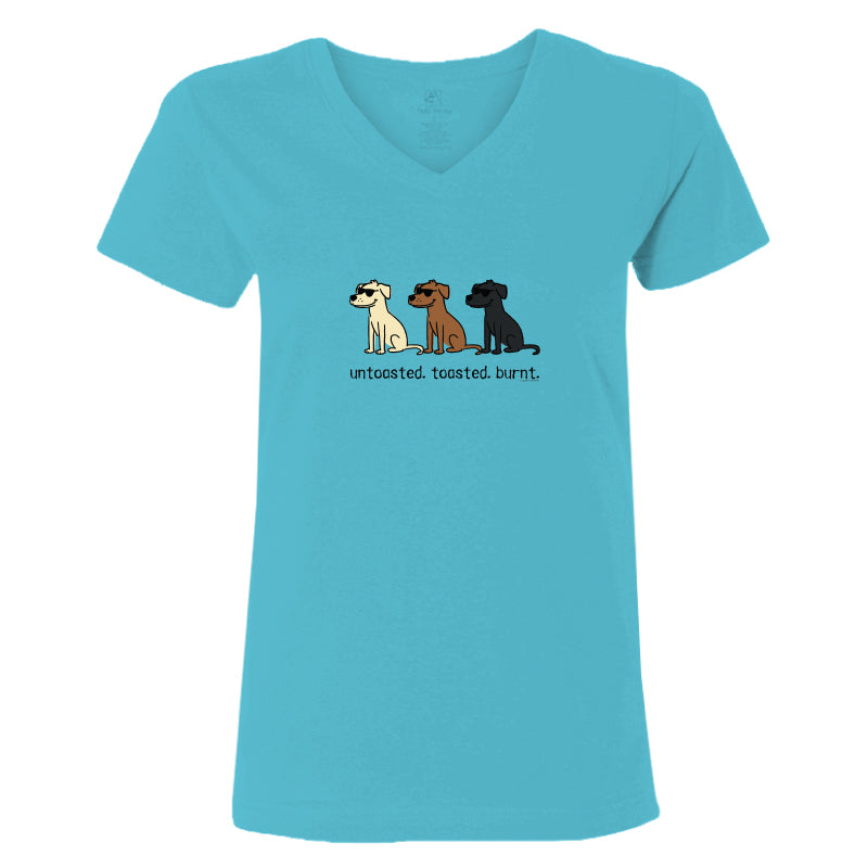 A women's short-sleeve V-neck t-shirt in a bright turquoise blue color, featuring a graphic of three cartoon dogs sitting in white, brown, and black, with the text 'untoasted. toasted.