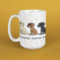 A white ceramic coffee mug with a handle, featuring a cartoon illustration of three dogs wearing sunglasses and the text 'toasted. toasted.