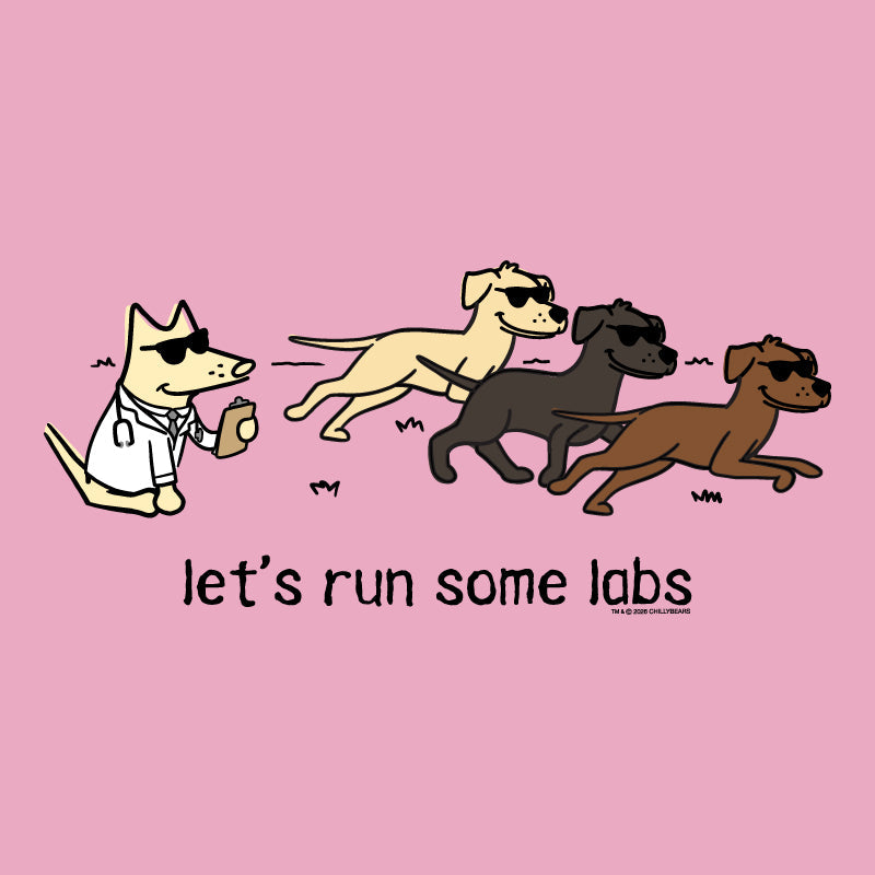 A pink graphic print featuring a cartoon dog in a white lab coat running behind three other dogs wearing sunglasses, with the text 'let's run some labs' below. Small text at the bottom right reads 'WE'VE BOTH OWNED DOGNAME'.