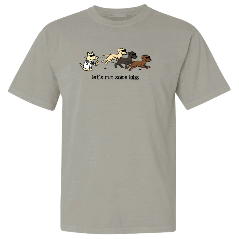 A light gray crewneck t-shirt featuring a cartoon graphic of a white cat chasing three dogs with the text 'let's run some labs' printed below.