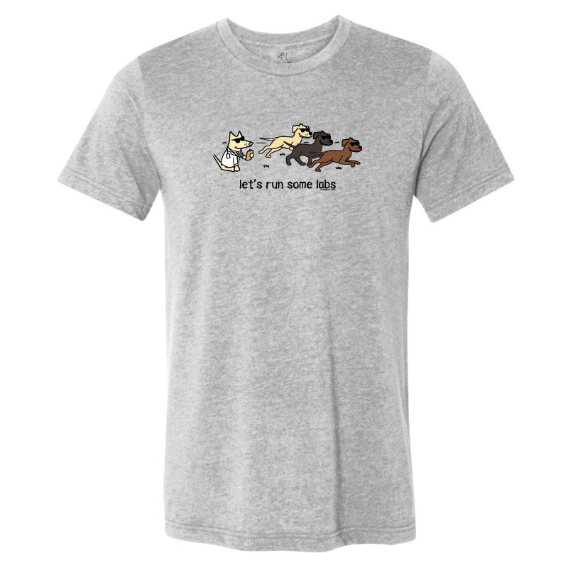 A heather gray short-sleeve crewneck t-shirt featuring a cartoon graphic of four dogs running with the text 'let's run some labs' printed below them.