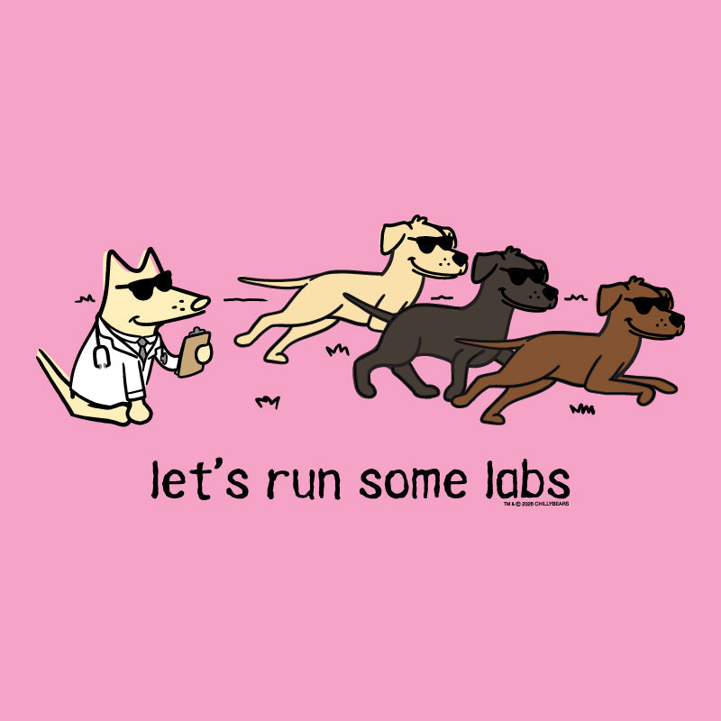 A pink graphic print featuring a cartoon illustration of four dogs running, with one dog in a white lab coat and sunglasses. Below the illustration, the text reads 'let's run some labs' in black lowercase letters.