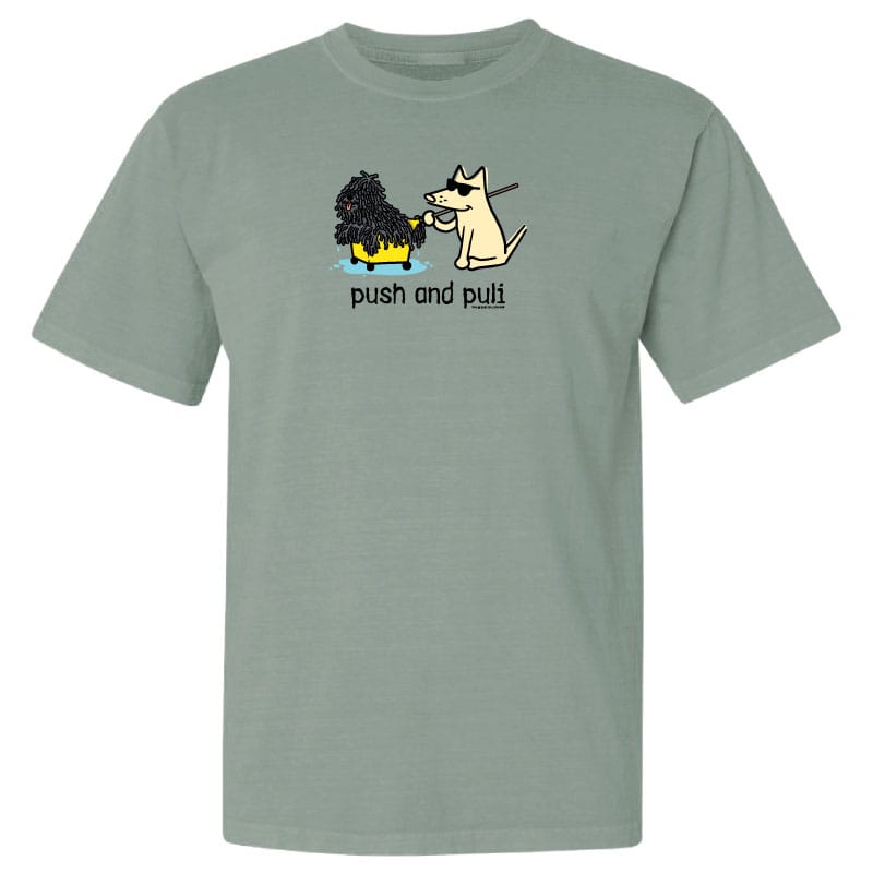 Green t-shirt with cartoon design of two dogs and text 'push and pull' on a white background