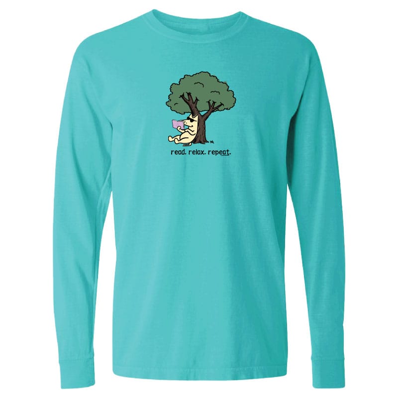A turquoise long-sleeve crewneck t-shirt with a cartoon graphic of a dog running under a tree and the text 'read. relax.
