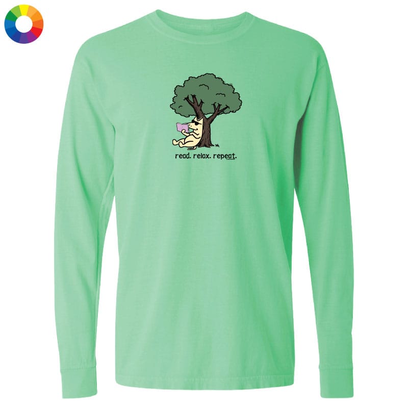 A mint green long-sleeve t-shirt with a cartoon graphic of a dog running under a tree and the text 'read. relax.