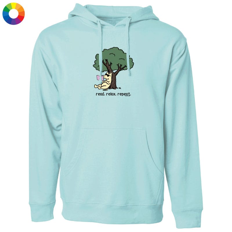 A light blue pullover hoodie with a front graphic of a cartoon dog sitting under a tree and the text 'read, relax, repeat.' on the chest, shown on a plain white background.