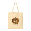 A natural beige canvas tote bag with two shoulder straps, featuring a central graphic of a dog's face framed by a colorful autumn wreath of sunflowers and leaves, with the text 'smells like fall' printed below.
