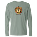 A sage green long-sleeve t-shirt with a graphic of a dog's face surrounded by autumn leaves and sunflowers, with the text 'smells like fall' printed below the graphic.