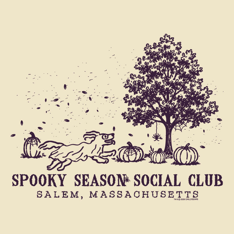 A vintage-style illustrated graphic on a warm cream background featuring a dark purple line drawing of a tree, pumpkins, falling leaves, and a running dog. Text below reads “SPOOKY SEASON SOCIAL CLUB” and “SALEM, MASSACHUSETTS.