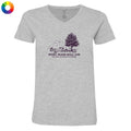 A light heather gray V-neck t-shirt with a dark purple graphic of a tree, sports equipment, and the text 'SPORTS SEASON SOCIAL CLUB' and 'SALEM, MASSACHUSETTS'. A small multicolor color wheel icon is in the top-left corner.