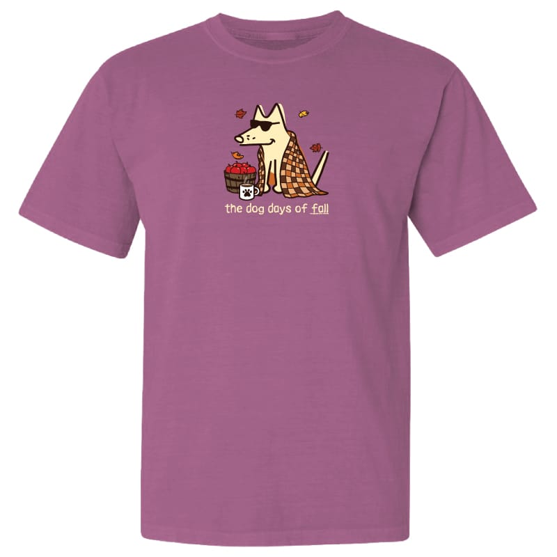 A heathered purple short-sleeve t-shirt with a cartoon graphic of a dog wearing sunglasses and a checkered blanket, holding a basket of red apples, with the text 'the dog days of fall' printed below.