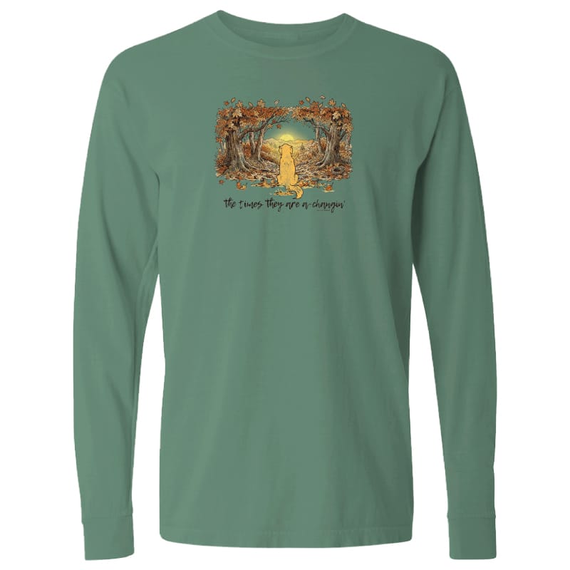 A sage green long-sleeve t-shirt with a graphic on the chest showing a yellow cat framed by autumn trees, with the text 'He knows they are a cat' underneath.