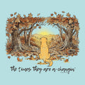A square graphic print featuring an illustration of a golden retriever sitting in the center of an autumn forest with falling leaves and mountains in the distance under a yellow sun. Below the illustration, the phrase 'the times they are a-changin'' is written in black script.