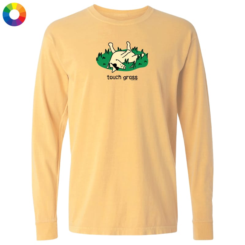 A pale yellow long-sleeve t-shirt with a graphic of a chicken lying in green grass and the text 'touch grass' printed below it, displayed on a solid white background.