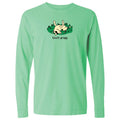 A mint green long-sleeve t-shirt with a graphic of a cartoon cat rolling on grass and the text 'touch grass' printed below it, displayed on a solid white background.